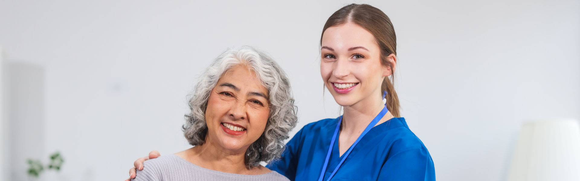 caregiver and old woman smiling
